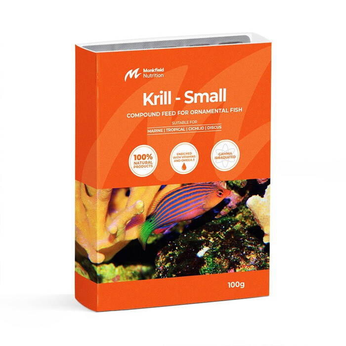 Packaging of Monkfield Nutrition Krill Small compound feed for ornamental fish, featuring an orange box with an image of a brightly colored fish near coral, suitable for marine, tropical, cichlid, and discus fish, enriched with vitamins and omega-3, and gamma irradiated for safety.